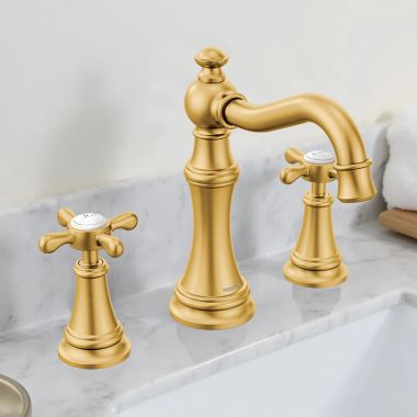 Click here to see Moen TVS42114BG Moen Weymouth Two-Handle Widespread Bathroom Faucet with Valve and Pop-Up Drain, Cross Handles, 1.2 GPM, Brushed Gold - TVS42114BG